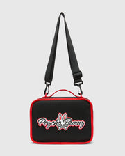 Kids Pal Lunch Box, black with vibrant red piping, featuring a prominent white and red embroidered Psycho Bunny skull logo on the front, complete with an adjustable black strap and red carry handle. (4)