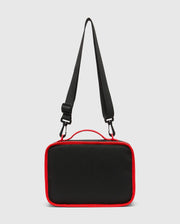 Kids Pal Lunch Box, sleek black durable fabric with vibrant red piping, a sturdy top handle, and an adjustable black shoulder strap featuring red carabiner clips. (3)