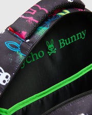 Kids Quintin Backpack in black with vibrant neon pink, blue, green, and white splatter bunny skull graphics, featuring a bright green Psycho Bunny logo and trim on the interior. (3)