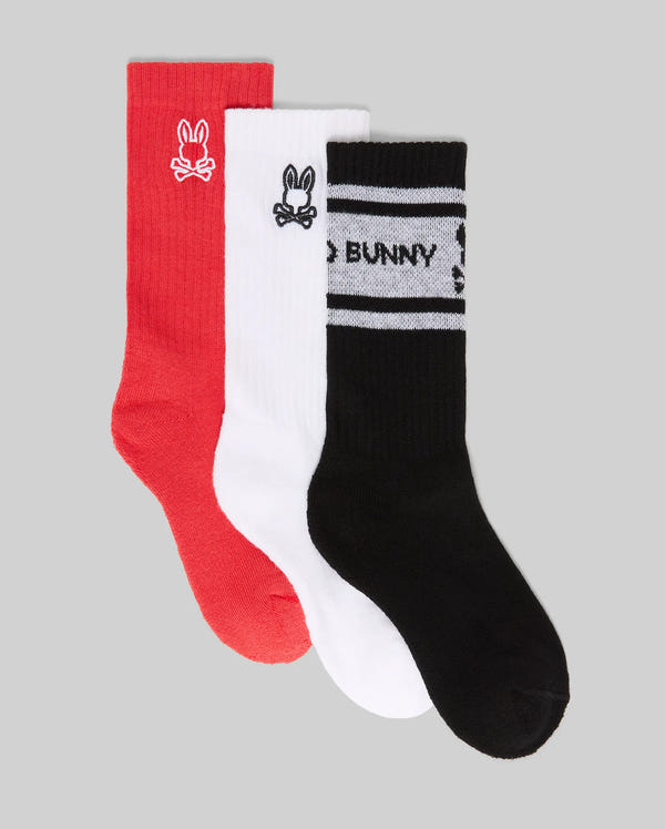 The Psycho Bunny KIDS 3 PACK SPORT SOCK (KO2200001) includes three pairs—red, white, and black—made with soft Pima cotton and spandex. Each features a bunny logo; the black pair adds two white stripes and "BUNNY" under the logo.