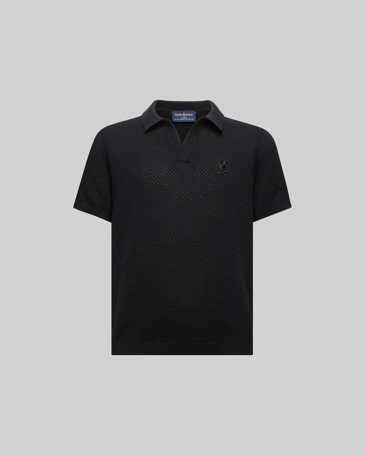 Kids Devon Knit Polo, black textured knit with a V-neck collar, classic fit, and a small tonal embroidered Psycho Bunny skull logo on the left chest.