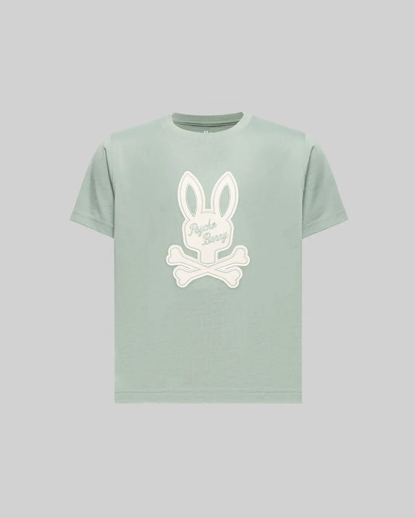 The Psycho Bunny KIDS DEREK CENTER GRAPHIC TEE (KT0200006) is a light green regular-fit short-sleeve T-shirt made from soft Pima cotton, featuring a large white bunny head with crossbones and "Psycho Bunny" text on the front.