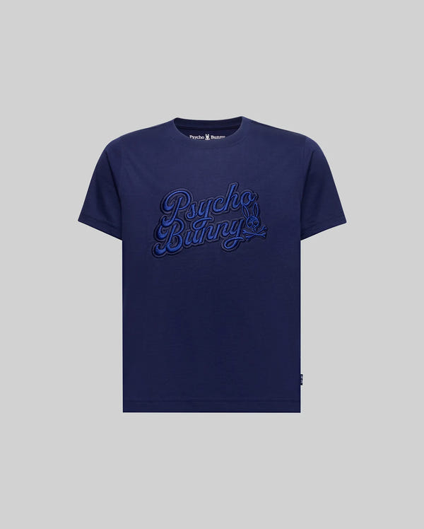 The KIDS ELIAS GRAPHIC TEE (KT0200013) by Psycho Bunny is a navy blue Pima cotton short-sleeve tee, featuring "Psycho Bunny" embroidered in blue script and a subtle Bunny graphic, shown on a light gray background.