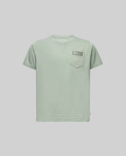 The KIDS AXTON POCKET TEE (KT0200034) by Psycho Bunny is a light green, short-sleeve Pima cotton tee with a left chest pocket and a small sewn rectangular label above it, shown on a plain light gray background.