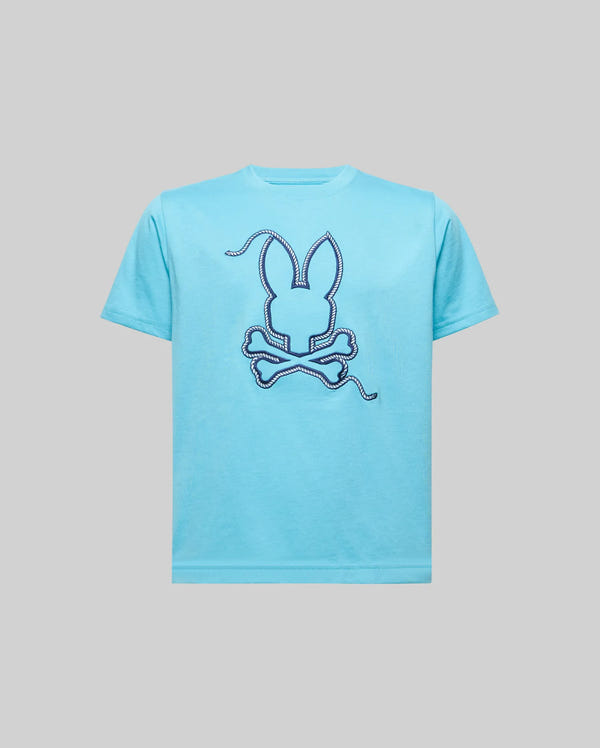 The KIDS CYRUS GRAPHIC TEE - KT0200047 by Psycho Bunny is a light blue 100% Pima cotton tee featuring a large bunny head with long ears above crossed bones, rope-style Bunny embroidery, stitched outline, and loose thread details.