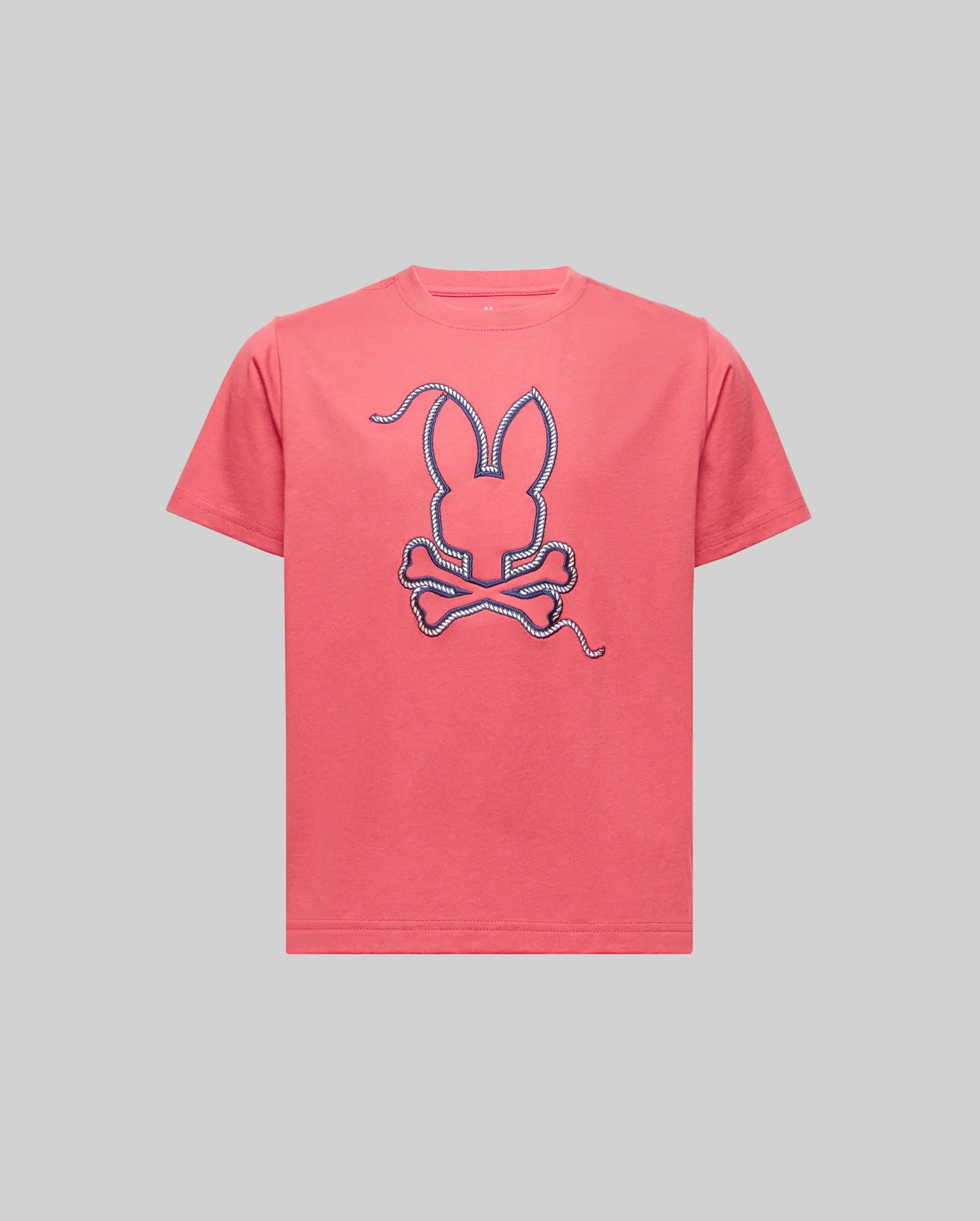 The KIDS CYRUS GRAPHIC TEE - KT0200047 by Psycho Bunny is a pink Pima cotton tee with a large bunny head and crossbones in a rope-like outline, evoking a sailor's spirit, shown against a plain gray background.