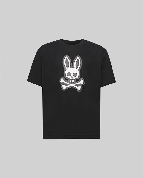 The Psycho Bunny KIDS RYDER OVERSIZED TEE (KT0200056) is a premium black Pima cotton T-shirt featuring a bold white skull with bunny ears above crossed bones, shown on a plain light gray background.