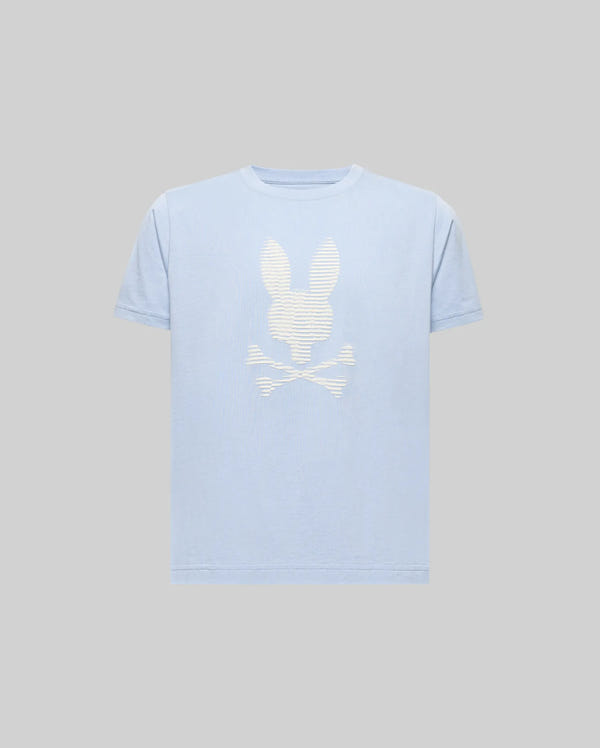 The KIDS GRANT BUNNY GRAPHIC TEE - KT0200061 by Psycho Bunny is a light blue, short-sleeve Pima cotton shirt with a bold white bunny head above crossed bones HD-printed on the front, shown against a plain gray background.