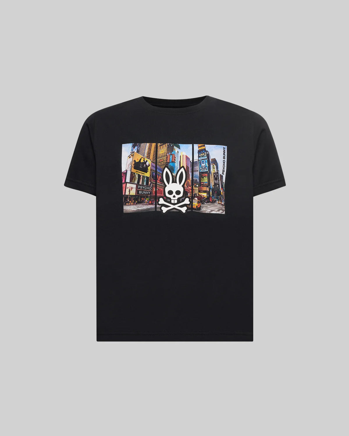 Kids Zeke Graphic Tee, a classic fit black jersey t-shirt featuring a vibrant Times Square graphic print on the chest, overlaid with a large white Psycho Bunny skull logo and vertical Psycho Bunny text.
