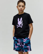Black Kids Van Graphic Tee, classic jersey, with a large pixelated purple Psycho Bunny skull logo on the chest. Paired with relaxed woven shorts in a teal and purple checkered pattern featuring integrated bunny skull logos.