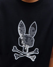 Kids Olivier Graphic Tee, black jersey knit with a large, central embroidered Psycho Bunny skull logo featuring a grey pixelated pattern and white outline, classic fit.