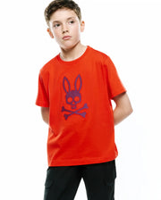 Kids Stan Graphic Tee in vibrant orange jersey knit, featuring a classic fit and a large central chest graphic of the iconic Psycho Bunny skull and crossbones logo in textured purple and blue. (4)