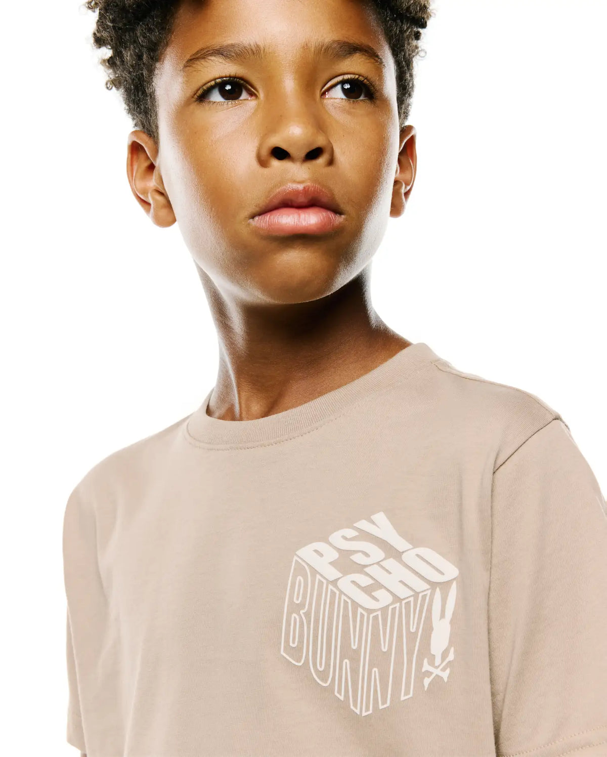 Kids Conan Back Graphic Tee in beige, featuring a classic fit and a large white 3D-effect PSYCHO BUNNY text graphic with the iconic bunny skull logo on the smooth jersey knit front. (3)