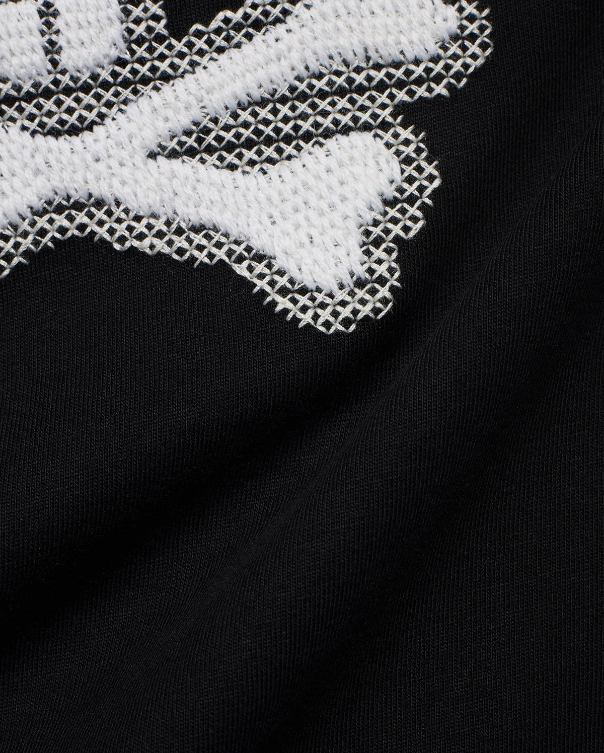 Kids' Samson Pima Graphic Tee in black Pima jersey knit, featuring a large white cross-stitch Psycho Bunny skull graphic. (6)