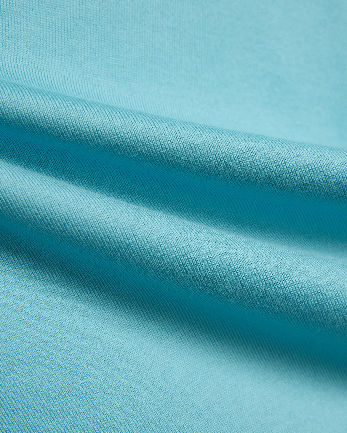 Kid's Norman Longsleeve Oversized Tee in vibrant aqua blue, showcasing its premium, finely woven cotton jersey knit fabric with soft, flowing drapes. (6)