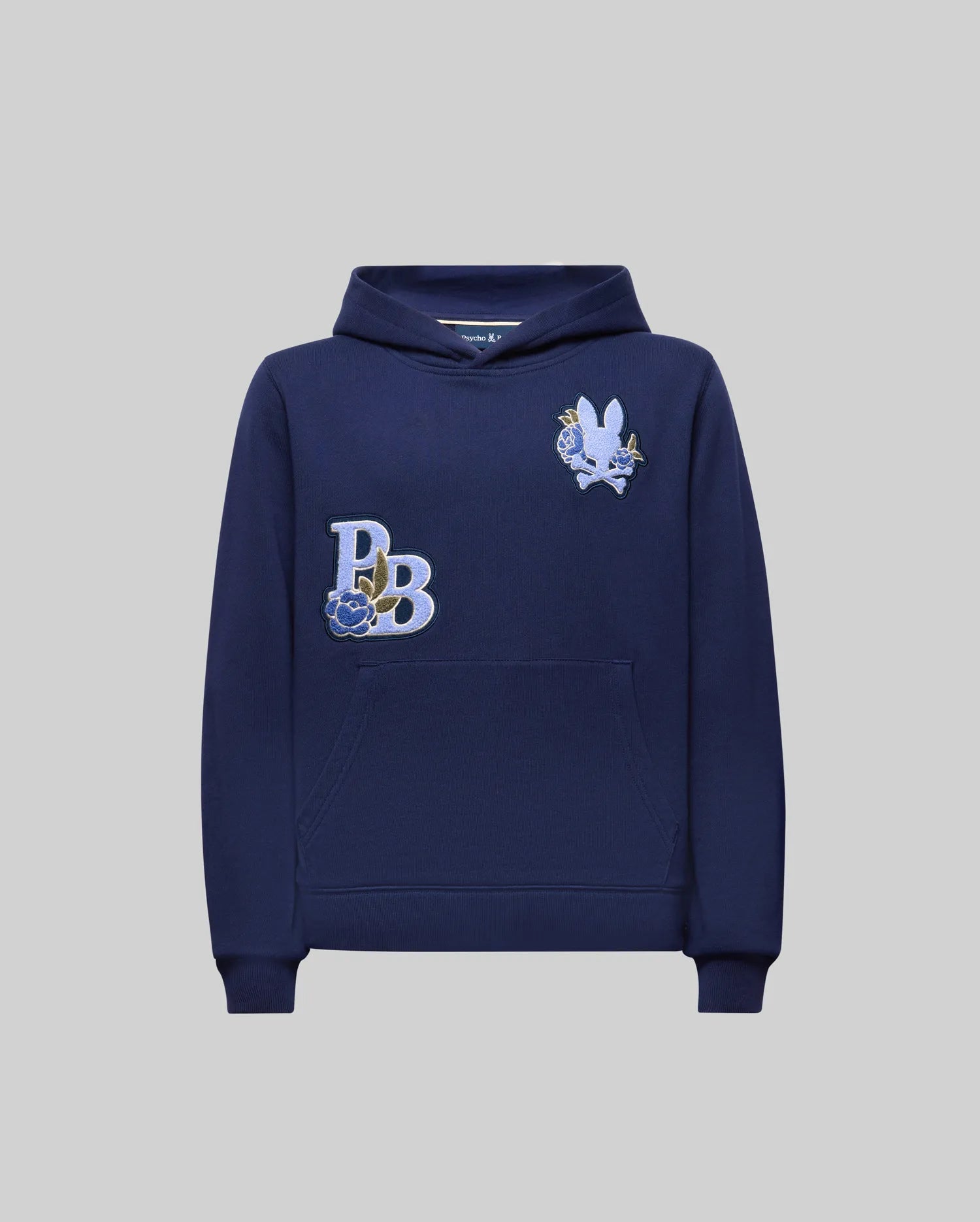 The KIDS AUGUSTE HOODIE - KT0500019 by Psycho Bunny is a navy cotton fleece, regular fit hoodie with a front pocket, "PB" embroidered monogram, and chenille floral detailing on a white-blue rabbit patch on the chest.