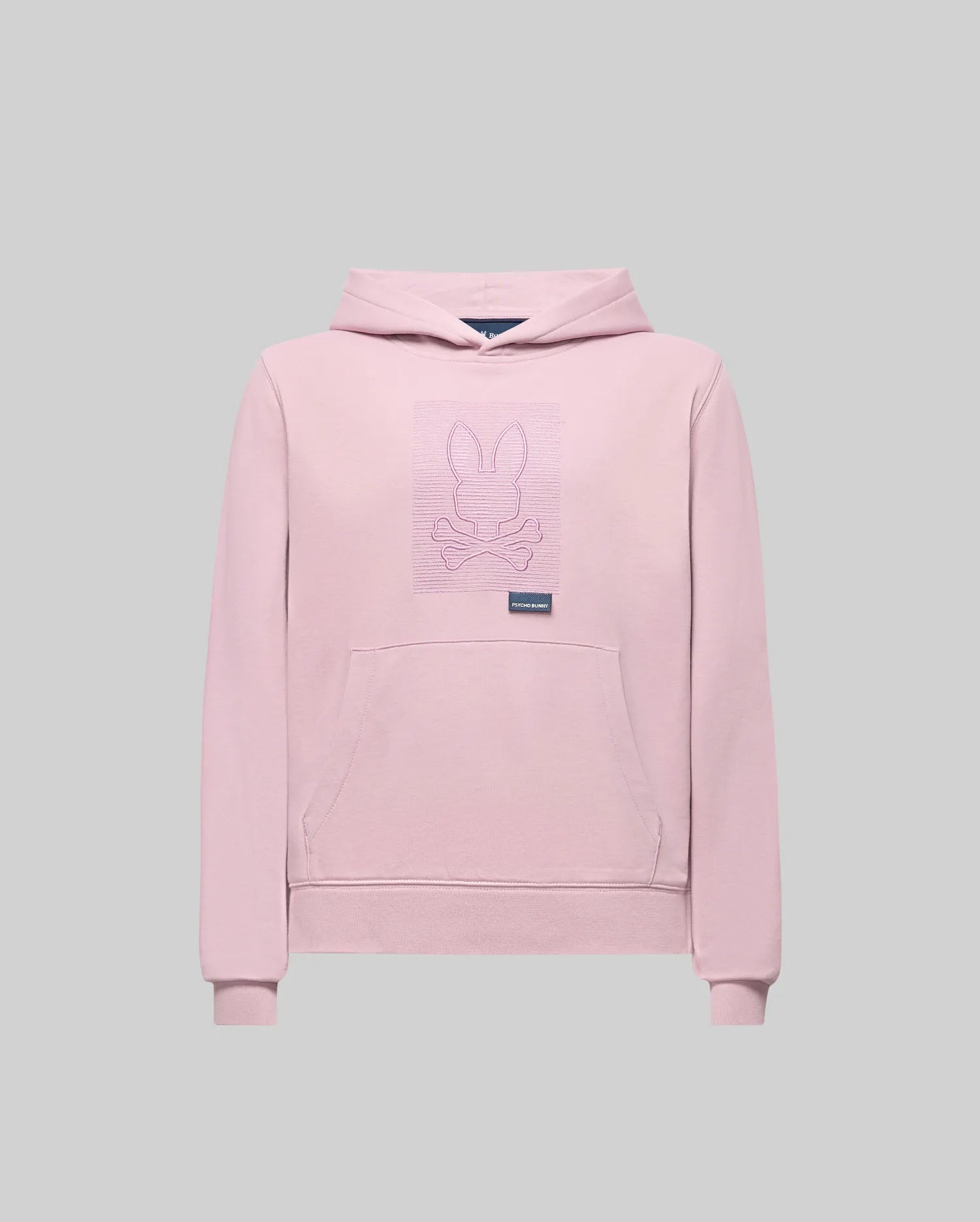 The KIDS GRANT HOODIE - KT0500020 by Psycho Bunny is a light pink premium cotton hoodie with a front pocket and a bunny with crossbones line art on the chest, shown in regular fit against a plain gray background.