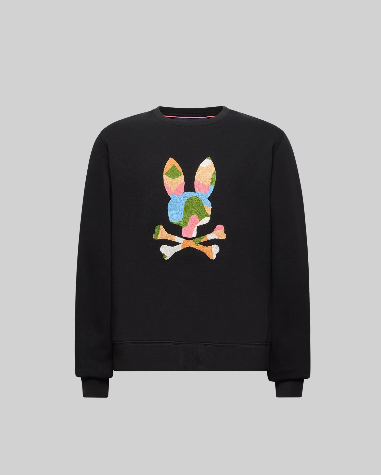 Black Kids Ara Crew sweatshirt, classic fit, featuring a large, central, embroidered Psycho Bunny skull logo in a vibrant, multi-colored, textured abstract camouflage pattern.