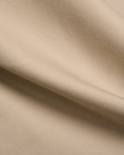 Mens Aidan Chino Pant in a warm khaki beige, featuring a refined, durable twill weave fabric with visible diagonal lines and a smooth, soft texture, draped in gentle folds. (6)