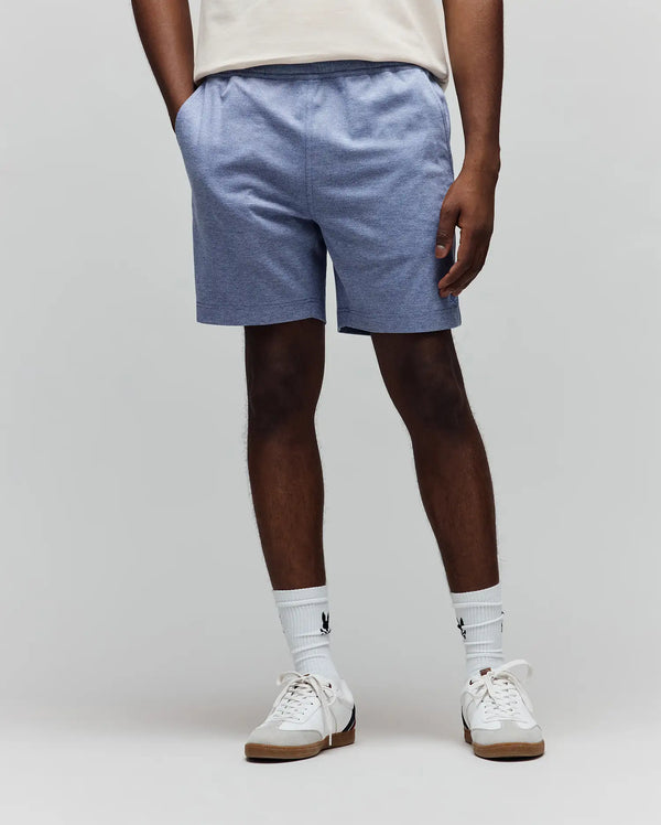 Mens Koda Oxford Short, heathered light blue, relaxed fit, soft knit fabric, featuring a small embroidered Psycho Bunny skull logo on the lower left leg and a comfortable drawstring waist.