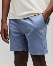 Mens Koda Oxford Short, heathered blue with a textured oxford weave, featuring a small, tonal embroidered Psycho Bunny skull logo on the lower left leg for a classic fit.