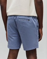 Mens Koda Oxford Short in heathered blue, featuring a relaxed fit, textured knit fabric, side pockets, and two back welt pockets with a small embroidered Psycho Bunny skull logo on the right.