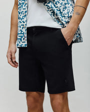 Mens Shiro Twill Short in black, featuring a classic fit and subtle twill texture. A small, tonal embroidered Psycho Bunny skull logo is on the lower left leg.