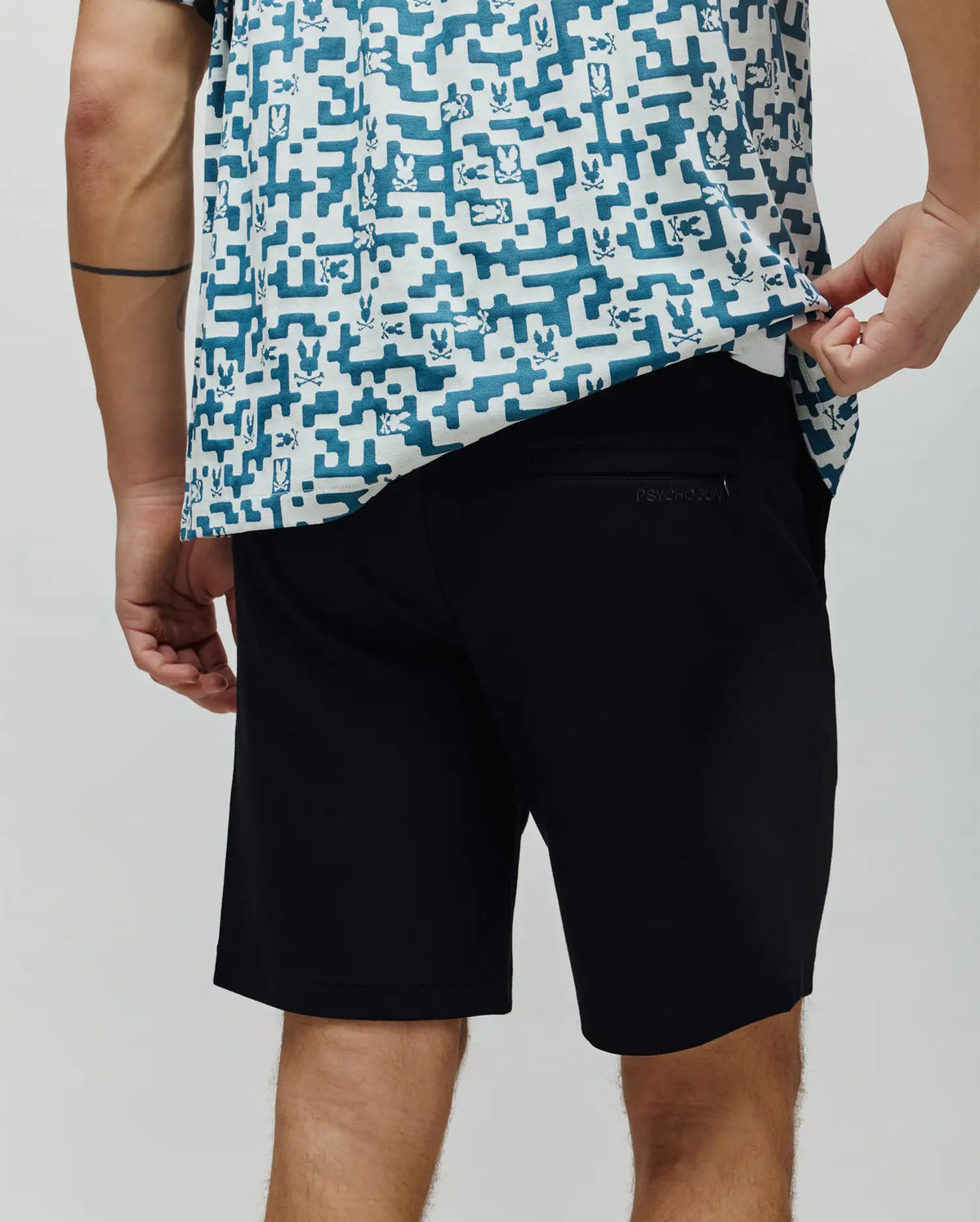 Black Mens Shiro Twill Short with a classic fit and smooth twill fabric, featuring a small embroidered Psycho Bunny text logo on the back right pocket.
