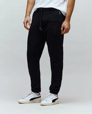 Mens Barry Joggers in black, featuring a relaxed fit, soft jersey knit, drawstring waist, and a tonal embroidered Psycho Bunny skull logo on the left thigh.