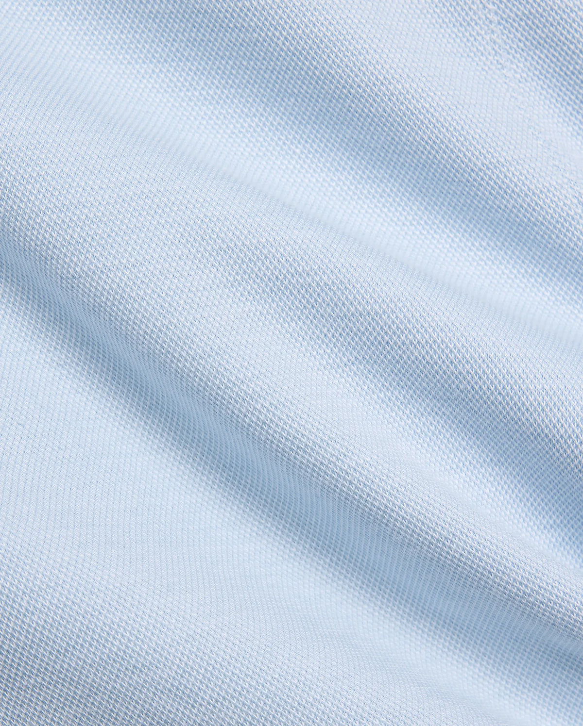 Mens Keith Short 8, showcasing a close-up of its premium light blue pique knit fabric, featuring a subtle, breathable texture, embodying Psycho Bunny's refined streetwear aesthetic. (6)