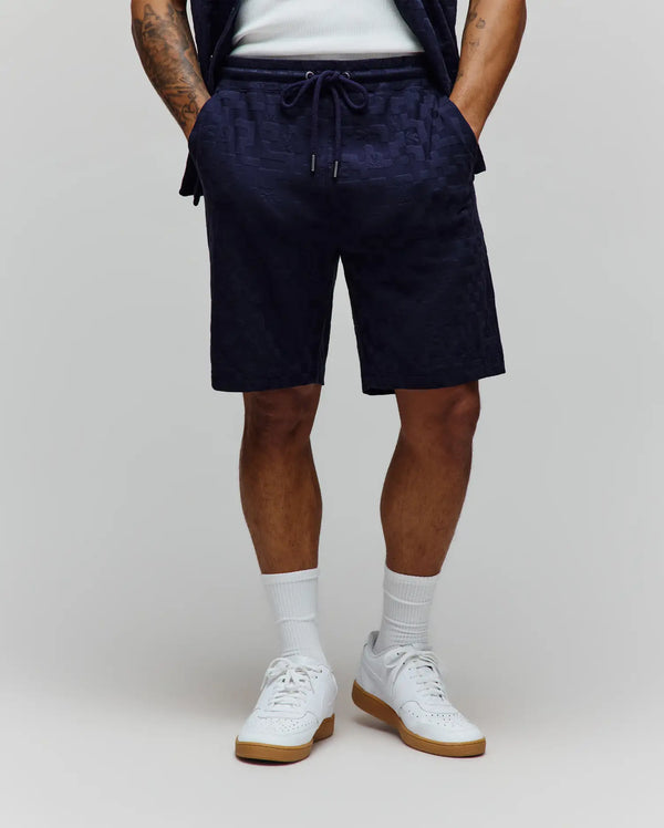 Mens Josh Jacquard Knit Short, navy relaxed fit shorts with a subtle all-over jacquard knit pattern of the Psycho Bunny skull logo and a drawstring waist with silver tips.