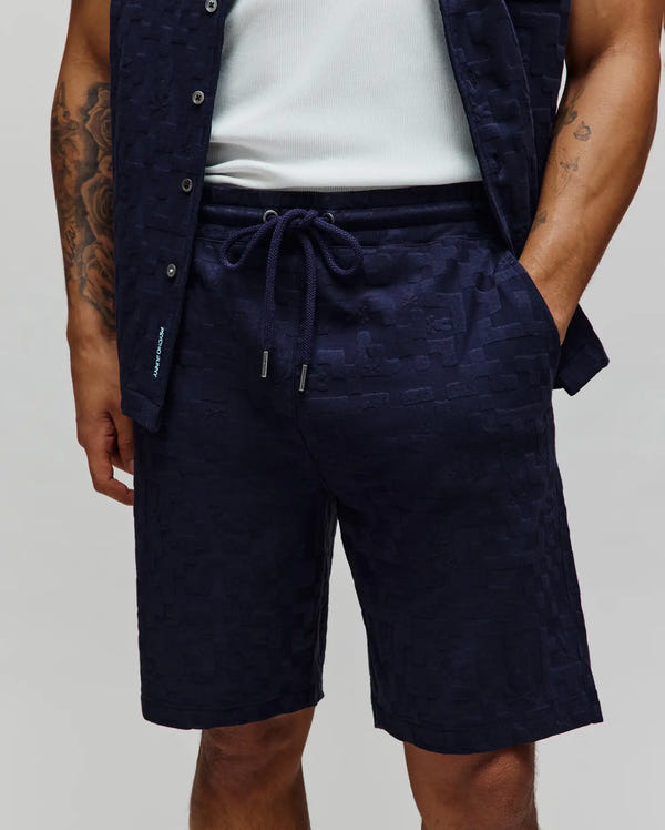Mens Josh Jacquard Knit Short in deep navy, showcasing a subtle tonal geometric jacquard pattern, a comfortable relaxed fit, and an adjustable drawstring waist with sleek silver tips.