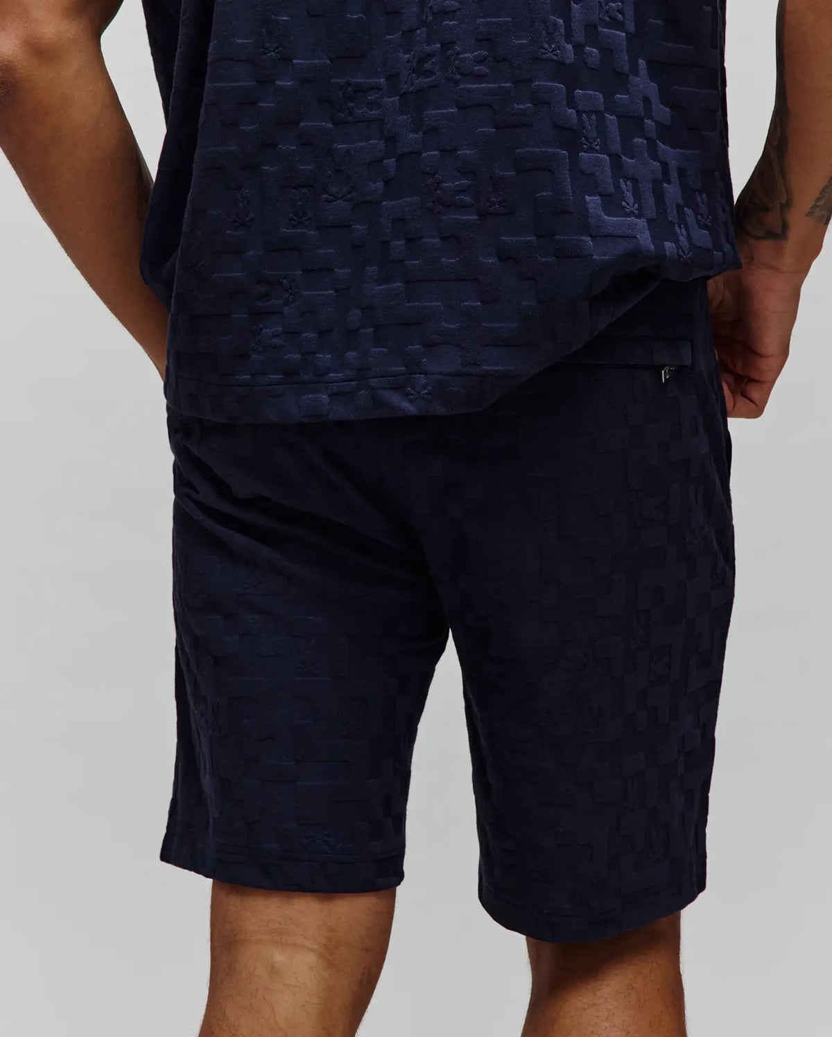 Mens Josh Jacquard Knit Short in navy, featuring a relaxed fit and an all-over tonal jacquard knit pattern of the iconic Psycho Bunny skull logo and geometric shapes.
