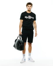 Black classic fit jersey t-shirt with large white Psycho Bunny script and red-eared bunny skull chest logo, paired with relaxed fit black Mens Marc Textured Short with drawstring waist. (4)