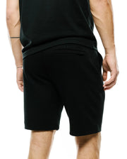 Mens Marc Textured Short, a black, relaxed-fit short crafted from a distinctive textured knit fabric, featuring subtle tonal embroidered Psycho Bunny branding on the back waistband. (3)