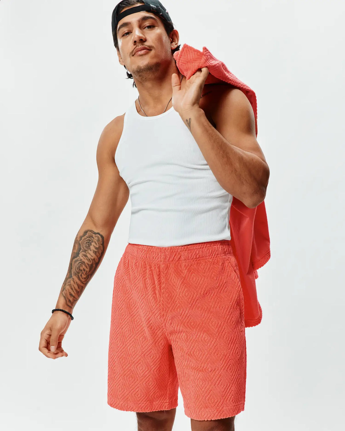 MENS TRISTAN SHORT, vibrant coral terry cloth shorts with a relaxed fit, featuring an all-over raised geometric diamond pattern, perfect for premium streetwear style. (2)