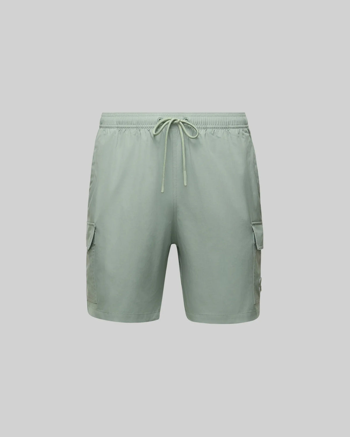 The Psycho Bunny MENS RANDY BOARD SWIM SHORT (MB1000002) features light green polyester, an elastic waistband with drawstring, and spacious cargo pockets—ideal for casual beachwear. Shown on a plain light gray background.