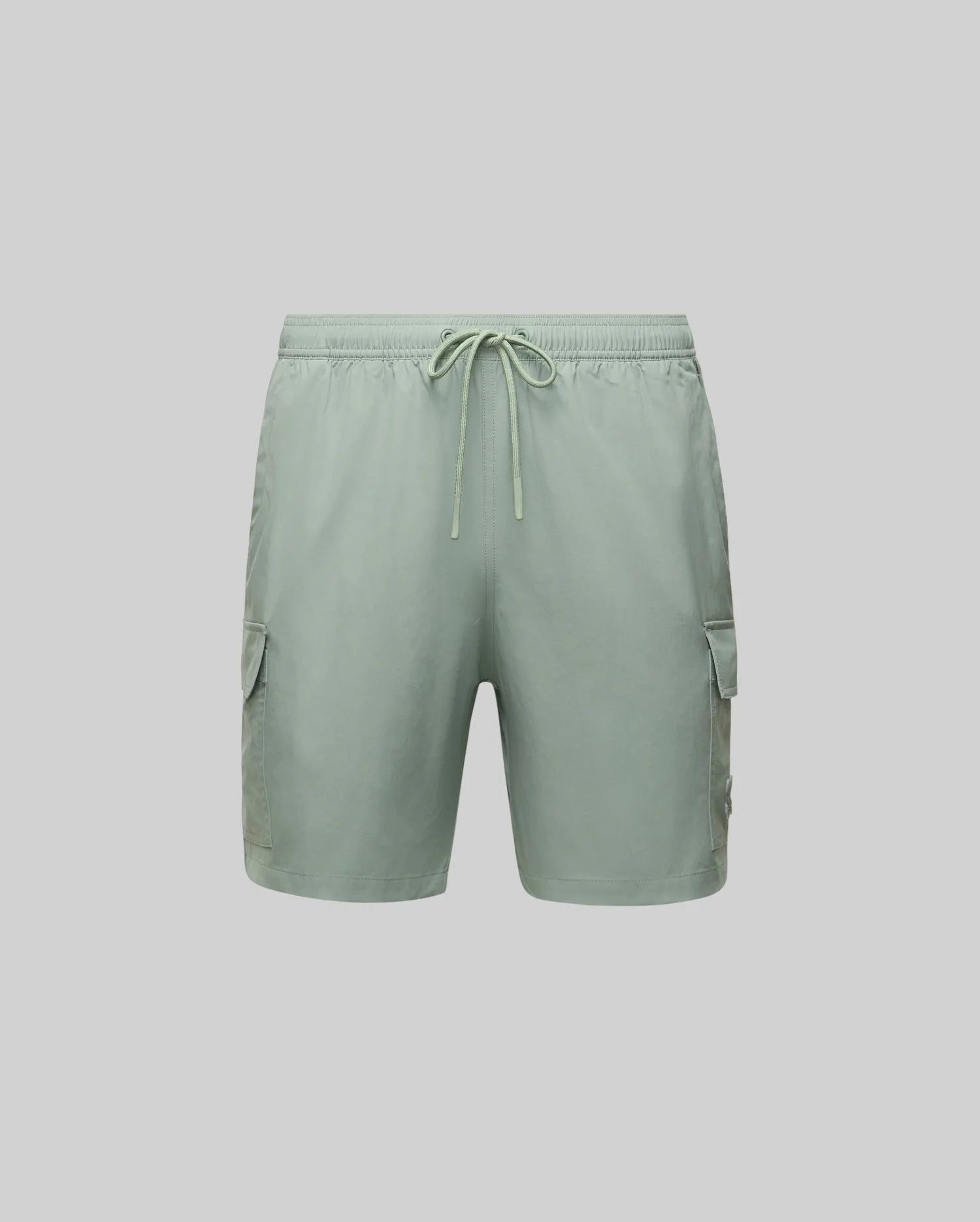 The Psycho Bunny MENS RANDY BOARD SWIM SHORT (MB1000002) features light green polyester, an elastic waistband with drawstring, and spacious cargo pockets—ideal for casual beachwear. Shown on a plain light gray background.