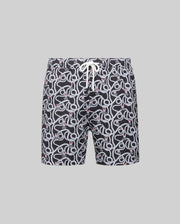 The MENS CYRUS ALL OVER PRINT SWIM TRUNK (MB1000004) by Psycho Bunny features a white and red snake pattern on black quick-dry seersucker, with a white drawstring waist, shown against a plain gray background.