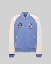 The Psycho Bunny MENS RYDER KNIT BOMBER (MO1100034) features light blue body, white sleeves, striped blue cuffs and collar, bunny patches, and an embroidered chest logo, shown against a plain grey background.