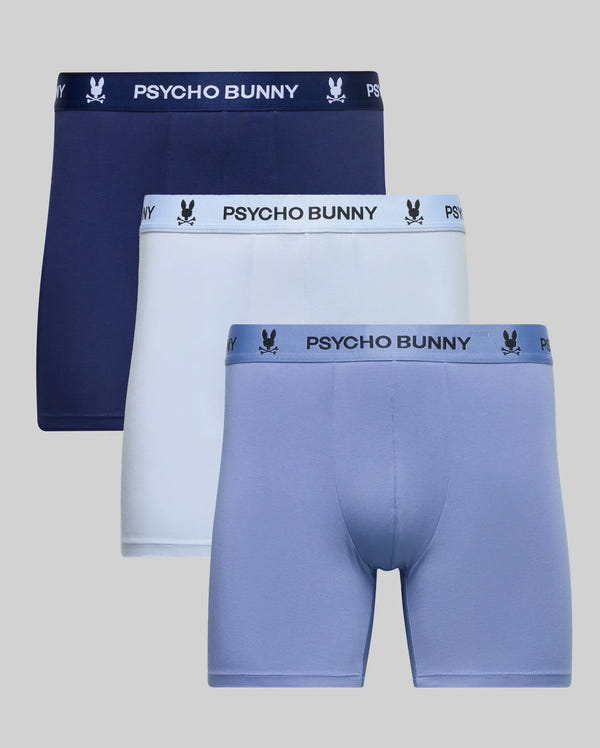 The Psycho Bunny MENS 3 PACK BOXER BRIEF (MO1400008) offers navy, white, and light blue stretch cotton-modal boxers with logo waistbands, shown against a plain gray background.