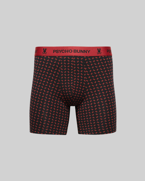 The MENS SINGLE BOXER BRIEF - MO1400010 by Psycho Bunny features soft black Pima cotton, a red bunny pattern, and a red "PSYCHO BUNNY" waistband, shown against a plain light gray background for stylish all-day comfort.