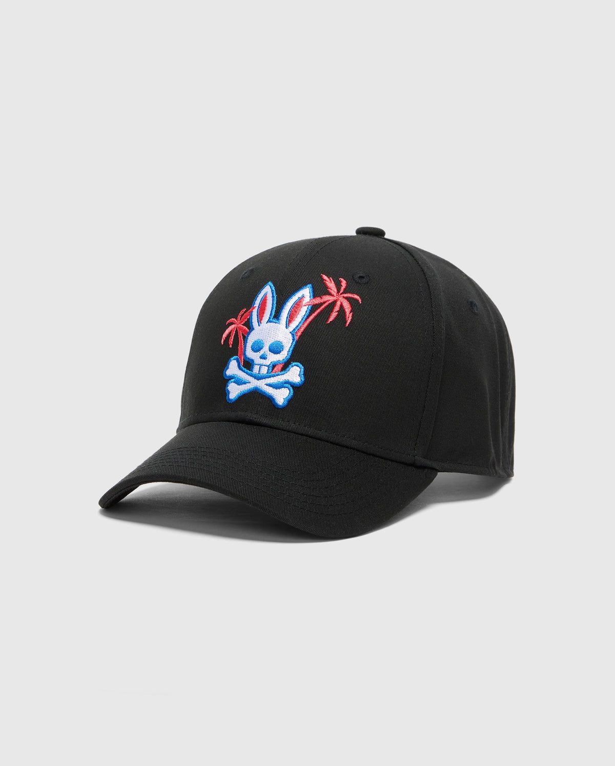 The MENS LOS ANGELES BASEBALL CAP - MO1500013 by Psycho Bunny features a detailed embroidered blue bunny head with crossbones and red palm trees on black cotton, set against a simple gray background.