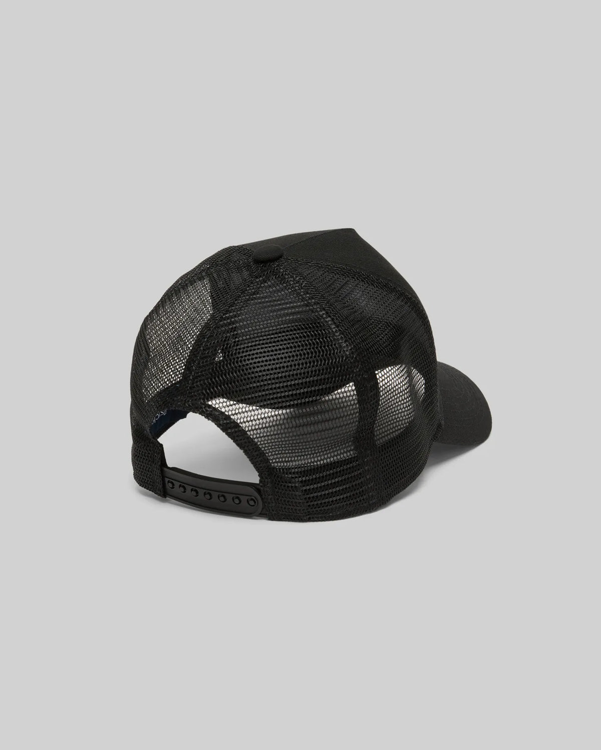The Psycho Bunny MENS AUGUSTE TRUCKER CAP (MO1500050) is shown from the back, highlighting its black mesh design and adjustable snapback closure against a plain gray background.