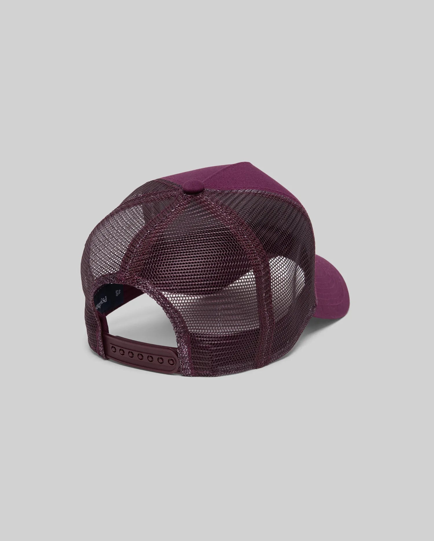 The Psycho Bunny MENS AUGUSTE TRUCKER CAP (MO1500050) is shown from the back in maroon, featuring mesh panels, a solid fabric front, and an adjustable snapback closure, set against a plain gray background.