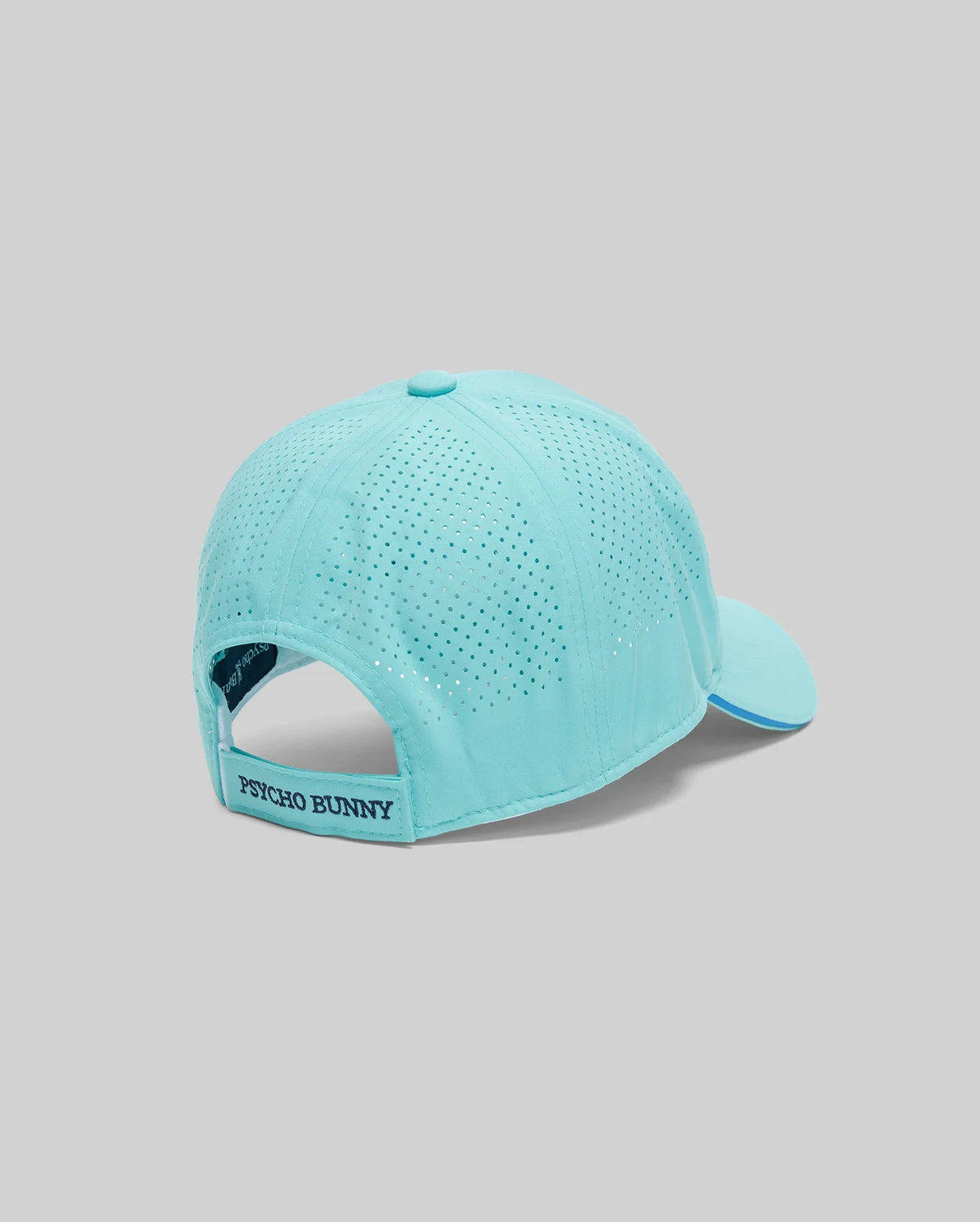The Psycho Bunny MENS OFFICIAL US OPEN AVERY NET SPORT CAP (MO1500086) in light blue features a perforated back for ventilation, an adjustable "Psycho Bunny" strap, and is displayed on a grey background—ideal for active days.