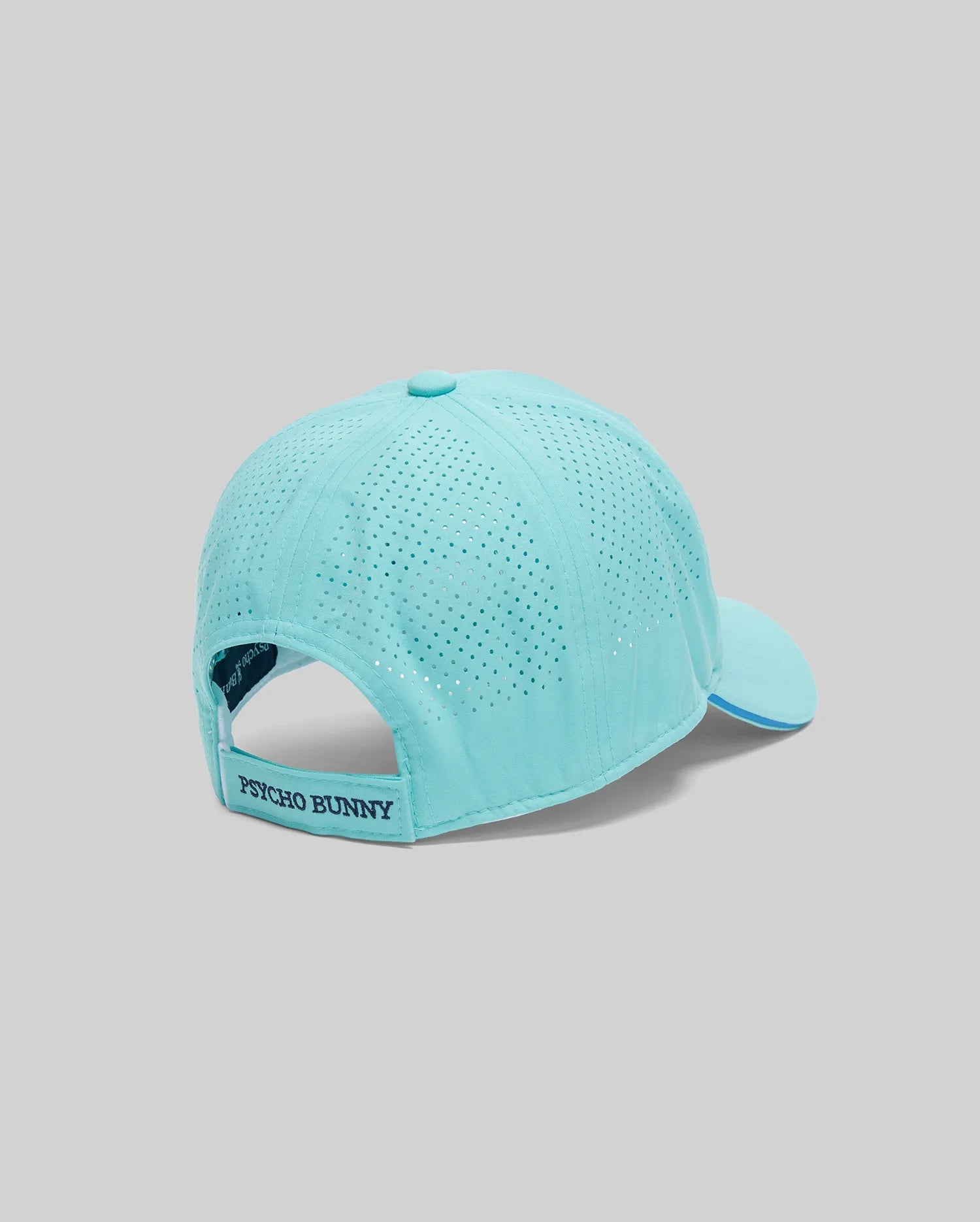 The Psycho Bunny MENS OFFICIAL US OPEN AVERY NET SPORT CAP (MO1500086) in light blue features a perforated back for ventilation, an adjustable "Psycho Bunny" strap, and is displayed on a grey background—ideal for active days.