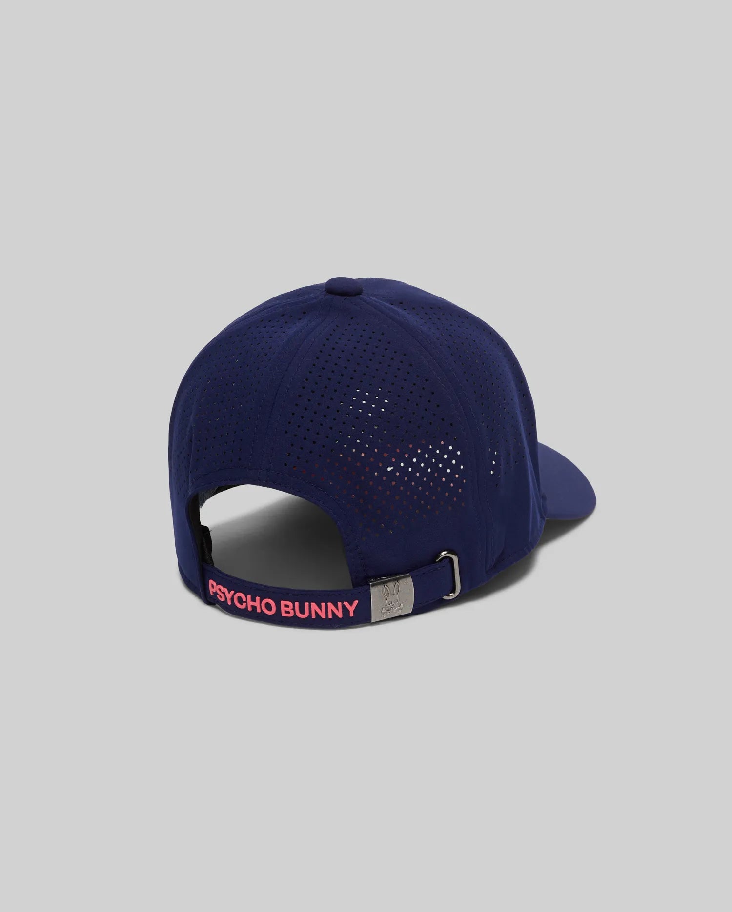 Mens Onyx Sport Cap, navy blue performance fabric with perforated panels, hot pink PSYCHO BUNNY text on back strap, and a small silver bunny skull logo on the adjustable buckle.