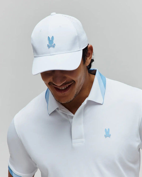 White pique polo with light blue collar and sleeve accents, featuring a small embroidered Psycho Bunny logo. White Mens Onyx Sport Cap with a light blue logo and perforated panels.