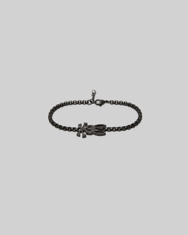 The Psycho Bunny MENS BUNNY BRACELET - MO1700018 features a black chain, a lobster clasp, and an "XO"-shaped pendant for timeless style, shown against a light gray background.